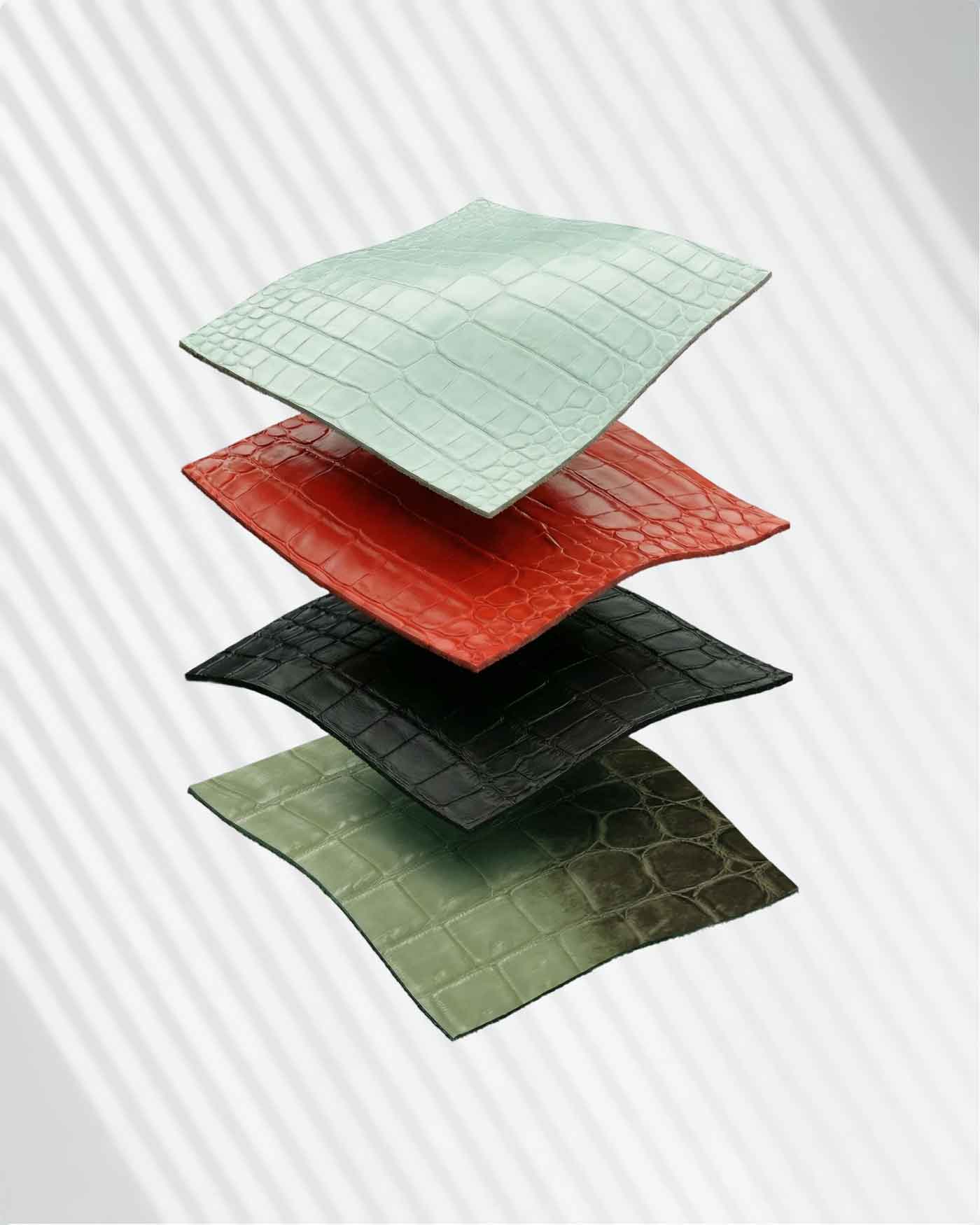 Layered exotic leather swatches in mint, red, black and olive